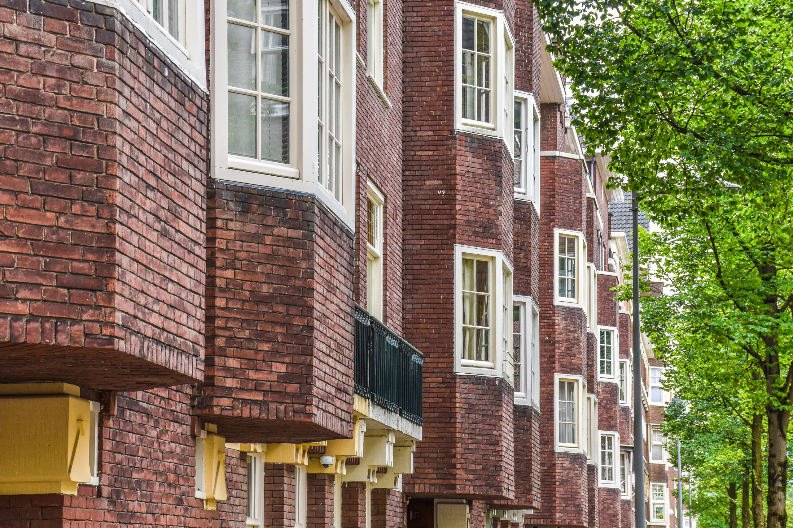 Brick residential buildings in a Dutch neighbourhood illustrating the housing market for international employees